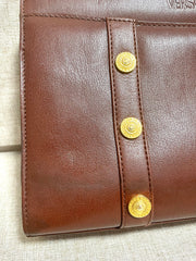 Vintage Gianni Versace brown leather wristlet, purse clutch, case bag with its iconic golden sunburst charms. Unisex bag. 061027y1