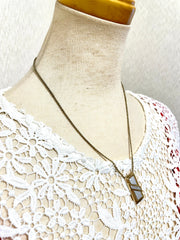 Vintage Christian Dior golden skinny chain necklace with logo embossed rectangular pendant top. 070131ys2