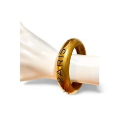 Vintage Chanel golden bangle with embossed black logo.  Must have gorgeous jewelry. 060810r1
