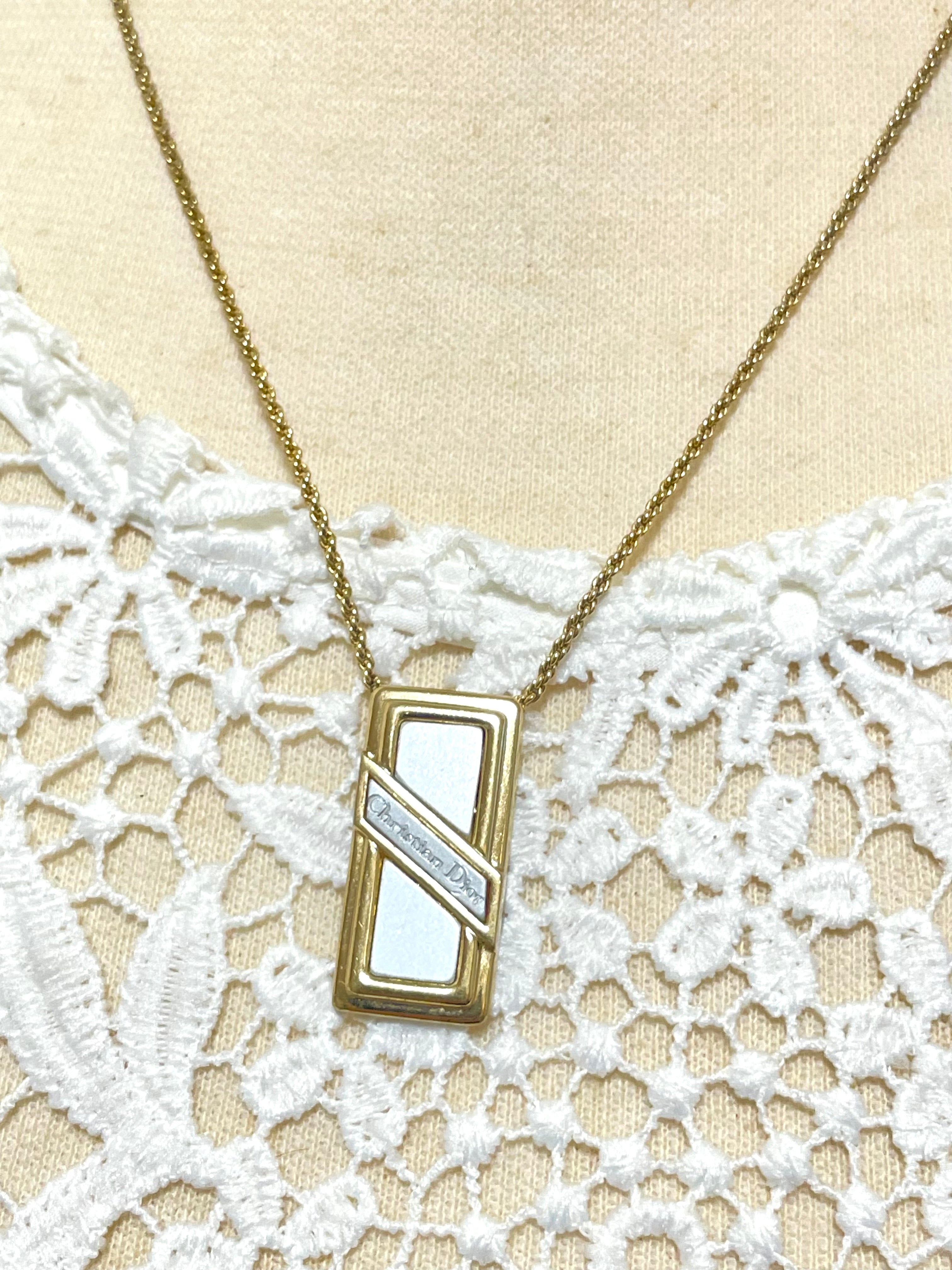 Vintage Christian Dior golden skinny chain necklace with logo embossed rectangular pendant top. 070131ys2
