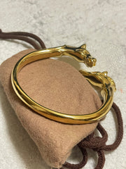 Vintage Hermes golden double horse head design bangle, bracelet. Beautiful classic jewelry from Hermes. 060220m