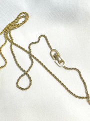 Vintage Christian Dior golden skinny chain necklace with logo embossed rectangular pendant top. 070131ys2