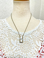 Vintage Christian Dior golden skinny chain necklace with logo embossed rectangular pendant top. 070131ys2