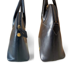 Vintage Roberta di Camerino black leather mini bolide bag with a gold tone logo charm. Classic piece for any occasion. 051227