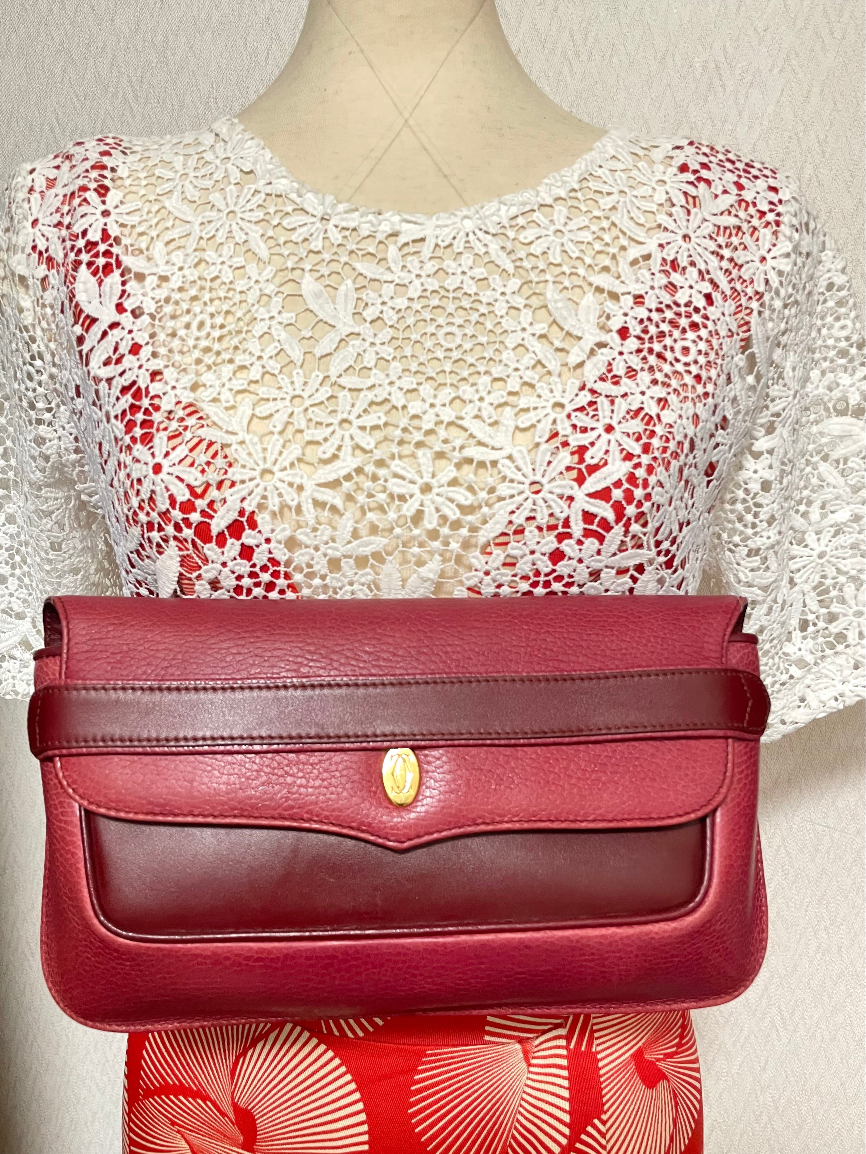 Vintage Cartier wine leather clutch bag with gold tone logo motif. Classic purse from must de Cartier Collection. 080114tr2