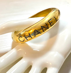 Vintage Chanel golden bangle with embossed black logo.  Must have gorgeous jewelry. 060810r1