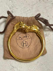 Vintage Hermes golden double horse head design bangle, bracelet. Beautiful classic jewelry from Hermes. 060220m