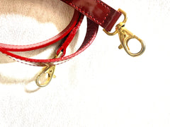 Vintage Christian Lacroix red patent enamel and leather bolide bag with golden logo zipper charm. Comes with shoulder strap. 0403172