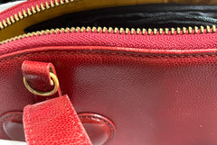 Vintage Christian Lacroix red patent enamel and leather bolide bag with golden logo zipper charm. Comes with shoulder strap. 0403172