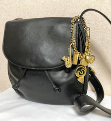 Vintage Moschino black leather shoulder bag with golden cute dangling charms. Heart, safety pin, trumpet, sacks, and guitar. 050725