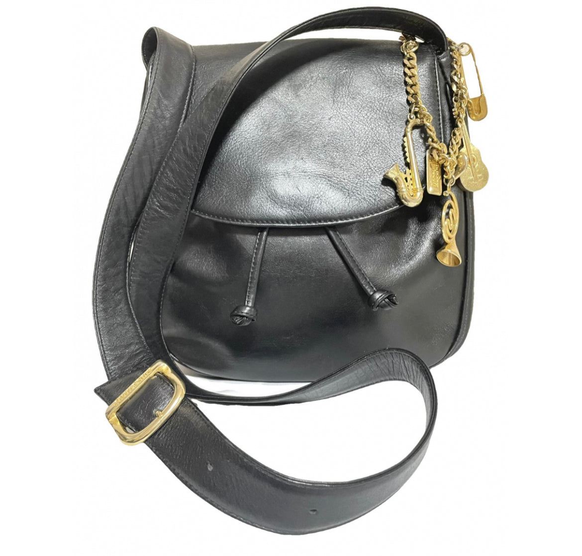 Vintage Moschino black leather shoulder bag with golden cute dangling charms. Heart, safety pin, trumpet, sacks, and guitar. 050725