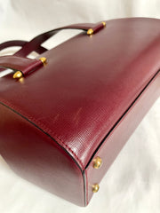Vintage Cartier classic wine, bordeaux leather handbag purse with bullet design gold hardware at handles. Must de Cartier. 0408171