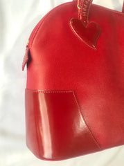 Vintage Christian Lacroix red patent enamel and leather bolide bag with golden logo zipper charm. Comes with shoulder strap. 0403172