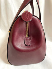 Vintage Cartier classic wine, bordeaux leather handbag purse with bullet design gold hardware at handles. Must de Cartier. 0408171