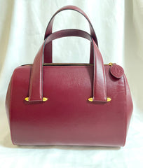 Vintage Cartier classic wine, bordeaux leather handbag purse with bullet design gold hardware at handles. Must de Cartier. 0408171