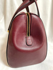 Vintage Cartier classic wine, bordeaux leather handbag purse with bullet design gold hardware at handles. Must de Cartier. 0408171