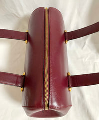 Vintage Cartier classic wine, bordeaux leather handbag purse with bullet design gold hardware at handles. Must de Cartier. 0408171
