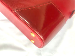 Vintage Christian Lacroix red patent enamel and leather bolide bag with golden logo zipper charm. Comes with shoulder strap. 0403172