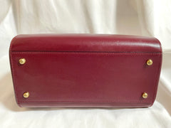 Vintage Cartier classic wine, bordeaux leather handbag purse with bullet design gold hardware at handles. Must de Cartier. 0408171