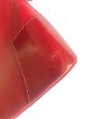 Vintage Christian Lacroix red patent enamel and leather bolide bag with golden logo zipper charm. Comes with shoulder strap. 0403172