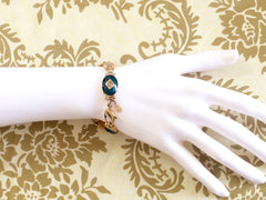 Vintage Burberrys golden gorgeous bracelet with oval emerald green and diamond shape charms with rhinestone crystals. Burberry jewelry.