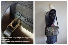 Vintage Hunting World khaki genuine leather shoulder purse with iconic gold tone elephant logo charm at front