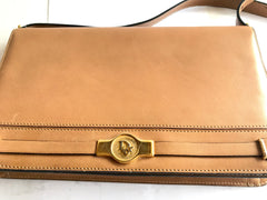 Vintage Christian Dior tanned brown leather shoulder clutch bag with golden CD motif.