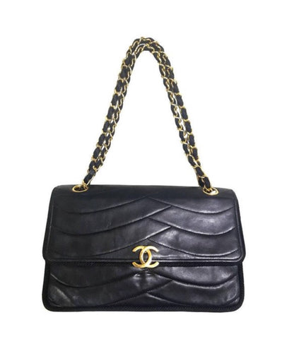 80's vintage Chanel black 2.55 shoulder bag with wavy stitches and rope strings and gold chain strap. Very rare piece from the era
