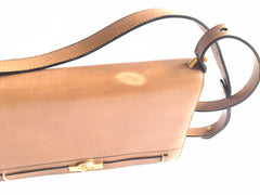 Vintage Christian Dior tanned brown leather shoulder clutch bag with golden CD motif.