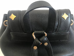 Vintage MCM black backpack with golden studded logo motifs and drawstrings. Designed by Michael Cromer. Unisex bag for daily use.