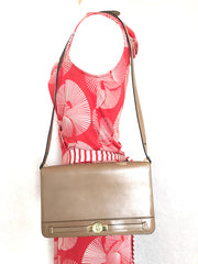 Vintage Christian Dior tanned brown leather shoulder clutch bag with golden CD motif.
