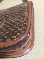 Vintage Gucci brown leather micro GG print shoulder bag with iconic golden large round GG motif. Rare masterpiece purse.