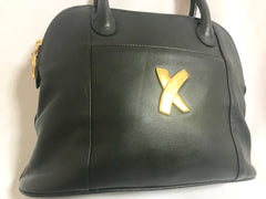 Vintage Paloma Picasso black leather bolide bag style handbag with iconic golden logo motif. Classic shape bag.