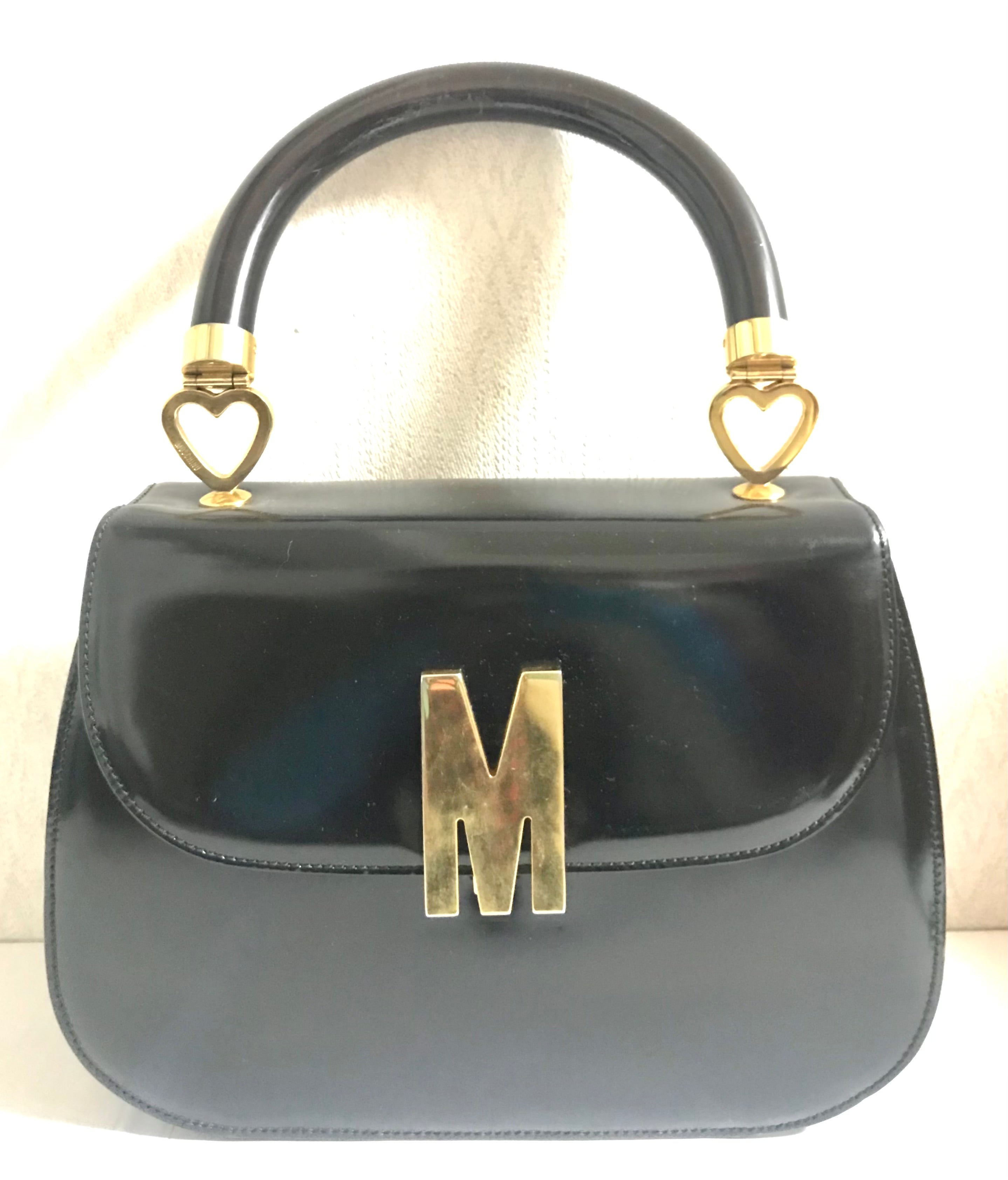 Vintage MOSCHINO black patent enamel Kelly style handbag with M logo and heart motifs. Masterpiece by Redwall. 050323re4