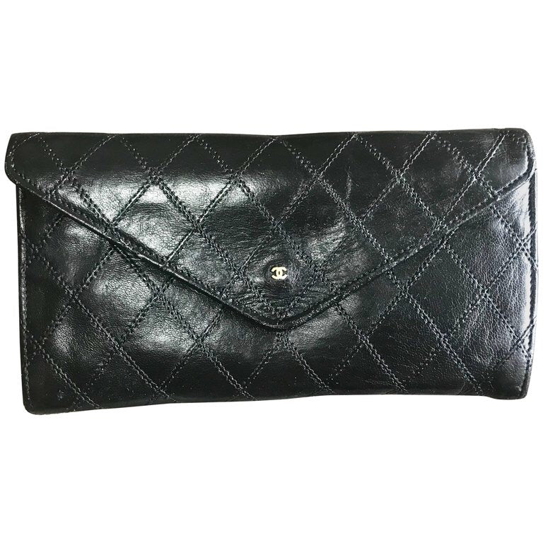 1980s. Vintage CHANEL black goatskin bill, card, checkbook long wallet pouch purse with  mini CC motif.  Classic unisex style.