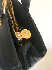 Vintage Gianni Versace large black nylon and leather combination tote bag with gold tone sunburst motifs and chains. 050425r4