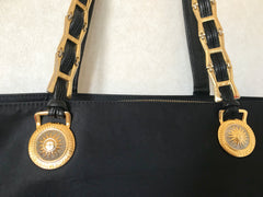 Vintage Gianni Versace large black nylon and leather combination tote bag with gold tone sunburst motifs and chains. 050425r4