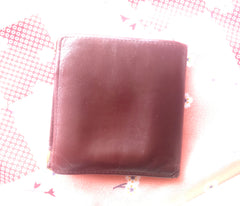 Vintage Cartier, must de Cartier wine leather square wallet with gold tone frames. Unisex use.