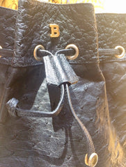80's vintage BALLY genuine black ostrich leather hobo bucket shoulder bag with golden B logo and drawstrings.