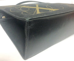 Vintage Paloma Picasso black canvas and leather combo shoulder bag with golden A B C D E F and S T V X Y letter print.