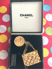 Vintage CHANEL Gold tone brooch with 2.55 classic purse and CC charms. Chic dangling brooch