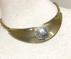 Vintage Celine gold tone crescent moon shape necklace with silver triomphe logo. 05062810
