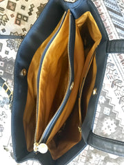 Vintage Gianni Versace large black nylon and leather combination tote bag with gold tone sunburst motifs and chains. 050425r4
