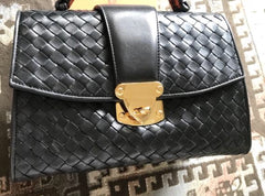 1990s. Vintage Bottega Veneta classic black lamb leather intrecciato handbag with golden closure hock. Gorgeous masterpiece from Bottega.