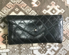 1980s. Vintage CHANEL black goatskin bill, card, checkbook long wallet pouch purse with  mini CC motif.  Classic unisex style.