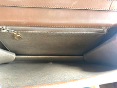 Vintage Christian Dior tanned brown leather shoulder clutch bag with golden CD motif.