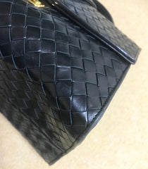 1990s. Vintage Bottega Veneta classic black lamb leather intrecciato handbag with golden closure hock. Gorgeous masterpiece from Bottega.