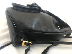 Vintage MCM black backpack with golden studded logo motifs and drawstrings. Designed by Michael Cromer. Unisex bag for daily use.
