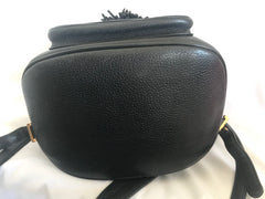 Vintage MCM black backpack with golden studded logo motifs and drawstrings. Designed by Michael Cromer. Unisex bag for daily use.