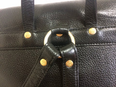 Vintage MCM black leather backpack with golden studded logo motifs. Designed by Michael Cromer. Unisex bag for daily use.